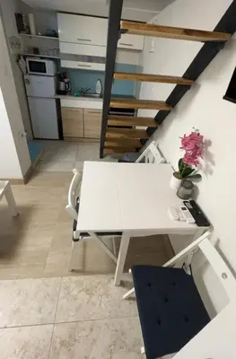 a white table and chairs in a kitchen at Cosy Corner Vič in Ljubljana