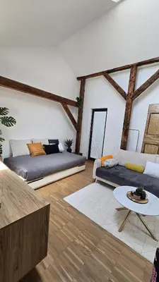 a living room with two couches and a table at Funky Stylish Penthouse in Ljubljana