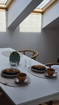 a table with three plates of food on it at Funky Stylish Penthouse in Ljubljana