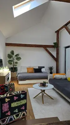 a living room with two couches and a table at Funky Stylish Penthouse in Ljubljana