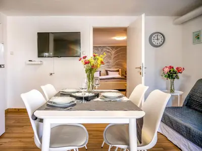 a dining room with a white table and chairs at Apartment Adelsberg Inn-2 by Interhome in Postojna