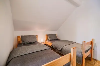 two twin beds in a room with white walls at 4 Bedroom Villa with Heated Indoor Pool Jajo & Pajo in Fala