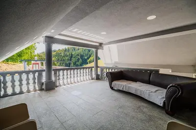 a couch sitting on a balcony with a view at 4 Bedroom Villa with Heated Indoor Pool Jajo & Pajo in Fala