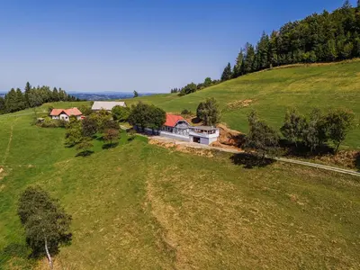 an aerial view of a house on a green hill at 4 Bedroom Villa with Heated Indoor Pool Jajo & Pajo in Fala