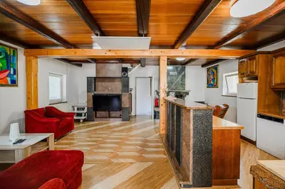 a living room with wooden ceilings and a red couch at 4 Bedroom Villa with Heated Indoor Pool Jajo & Pajo in Fala