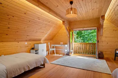 a bedroom with a bed in a wooden cabin at Old Castle Lodge in Kamnik
