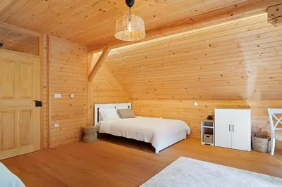 a bedroom with a bed in a wooden cabin at Old Castle Lodge in Kamnik