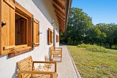 two wooden benches sitting on the side of a building at Old Castle Lodge in Kamnik