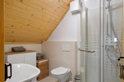 a bathroom with a toilet and a glass shower at Old Castle Lodge in Kamnik