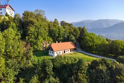 an aerial view of a house on a hill with a road at Old Castle Lodge in Kamnik