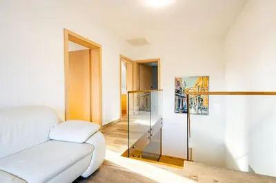 a living room with a couch and a glass door at Villa Aqua in Moravske Toplice