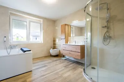 a bathroom with a shower and a sink and a toilet at Villa Aqua in Moravske Toplice
