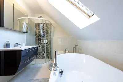 a bathroom with a white tub and a shower at Villa Aqua in Moravske Toplice