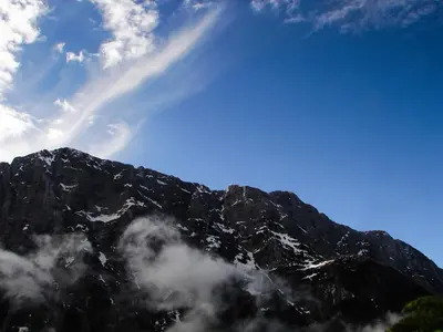 a view of a mountain with clouds in front of it at Apartment Pohar in Log pod Mangartom
