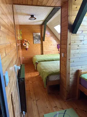 a room with two beds in a log cabin at Apartment Pohar in Log pod Mangartom