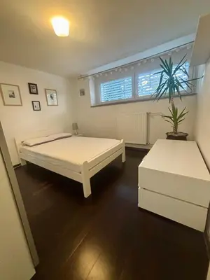 a bedroom with two beds and a window at Betnava Apartment in Maribor