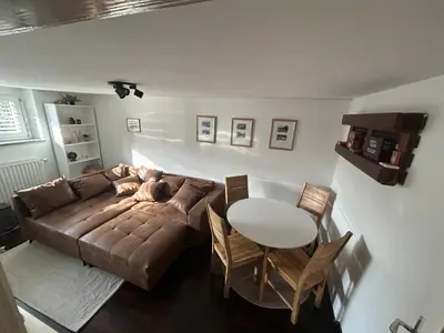 a living room with a couch and a table at Betnava Apartment in Maribor
