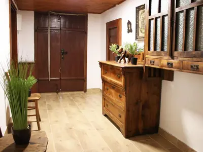 a room with a wooden dresser and a wooden door at Vineyard cottage Ranč pri Hanzeku in Zgornji Leskovec
