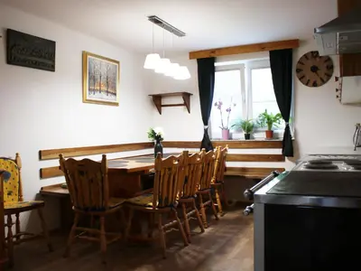 a kitchen with a table and chairs and a window at Vineyard cottage Ranč pri Hanzeku in Zgornji Leskovec