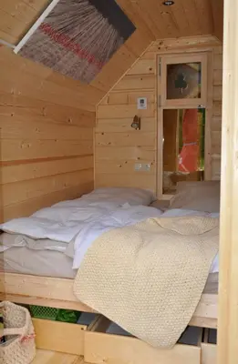 a room with two beds in a wooden cabin at Kamp Jankovic in Gorenjcj