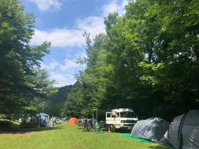 a group of tents and a group of people in a field at Kamp Jankovic in Gorenjcj