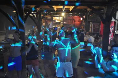 a group of women dancing in a room with blue lights at Kamp Jankovic in Gorenjcj