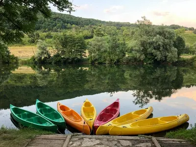 a group of five kayaks sitting on the water at Kamp Jankovic in Gorenjcj