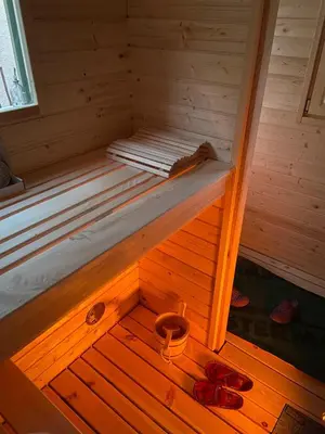 a wooden sauna with two pairs of shoes in it at Mountain Escape with Sauna in Kobarid