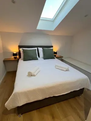 a bedroom with a large bed with two towels on it at Mountain Escape with Sauna in Kobarid