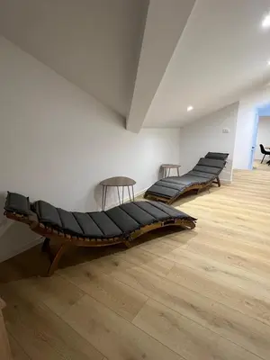 three beds in a room with a wooden floor at Mountain Escape with Sauna in Kobarid
