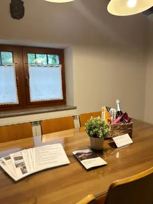 a table with a book and a basket of flowers at Karol-ina Estate in Branik