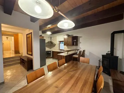 a kitchen and dining room with a wooden table and chairs at Karol-ina Estate in Branik