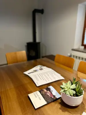 a table with a book and a bowl of plants on it at Karol-ina Estate in Branik