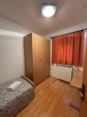 a small room with a bed and a cabinet at Karol-ina Estate in Branik
