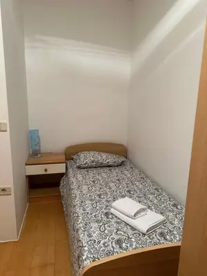 a small bedroom with a bed and a table at Karol-ina Estate in Branik