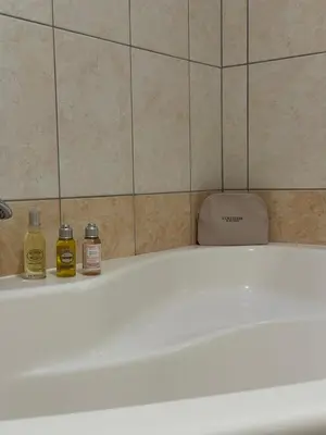 a bath tub with two bottles of essential oils on it at Karol-ina Estate in Branik