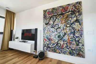 a living room with a large painting on the wall at Alpine View Premium in Komenda