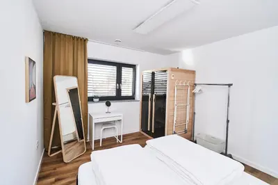 a bedroom with two beds and a vanity and a mirror at Alpine View Premium in Komenda