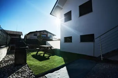 a patio with a picnic table and a building at Alpine View Premium in Komenda