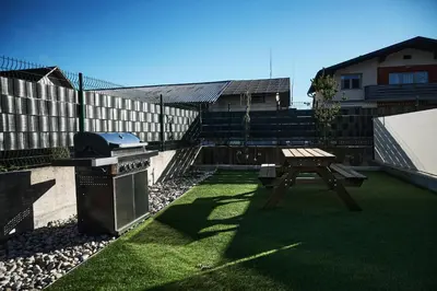 a backyard with a picnic table and a grill at Alpine View Premium in Komenda