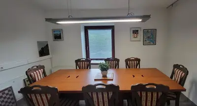 a dining room with a wooden table and chairs at Caissa - Spacious house in quiet location in Tolmin