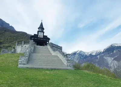 a clock tower on top of a building on a hill at Caissa - Spacious house in quiet location in Tolmin