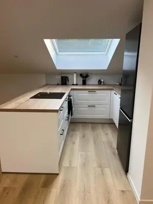a kitchen with a skylight in the ceiling at Charming Alpine Apartment with Sauna in Kobarid