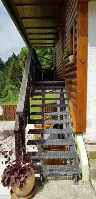 a wooden staircase on a porch of a house at Penzion Pr' Betel in Jesenice