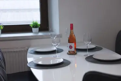 a table with two glasses and a bottle of wine at M&M apartma in Bohinj