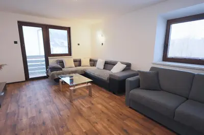 a living room with a couch and a table at M&M apartma in Bohinj