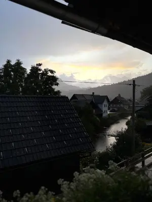 a view of a river with mountains in the distance at M&M apartma in Bohinj