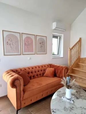 a living room with a couch and a glass table at Domačija Rajsko srce in Šentjur