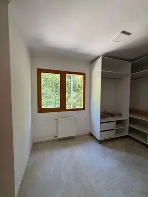 an empty room with a window and a shelf at Cozy Mountain Stay near Kranjska Gora in Gozd Martuljek