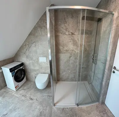 a shower stall in a bathroom with a toilet at Crown Residence Luxury 2BR in Ljubljana Downtown in Ljubljana